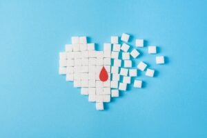 Heart cubes forming a blood drop in the center with a light blue background